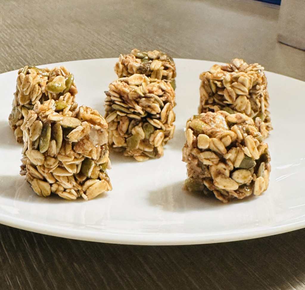 no-bake pumpkin seed energy bites displayed in a mini bon tray, showcasing bite-sized snacks made with oats, pumpkin seeds, and nut butter, ready to enjoy!