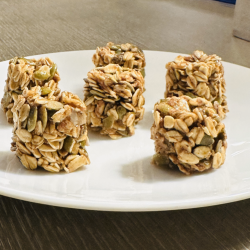 no-bake pumpkin seed energy bites displayed in a mini bon tray, showcasing bite-sized snacks made with oats, pumpkin seeds, and nut butter, ready to enjoy!