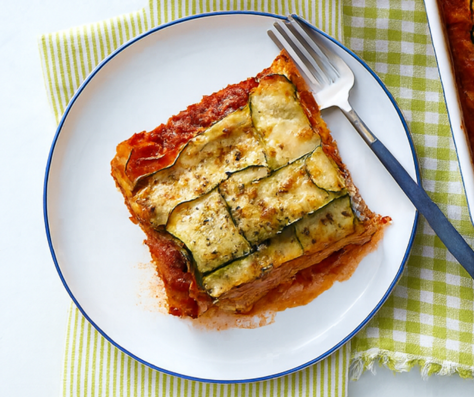 Sliced Zucchini Lasagna with Basil Paste served on a white plate over a green checkered napkin
