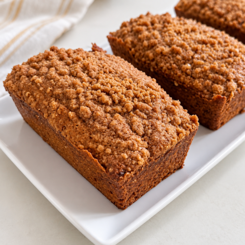 Pumpkin Spice Latte Coffee Cake Loaves topped with espresso cinnamon streusel on a white serving plate.