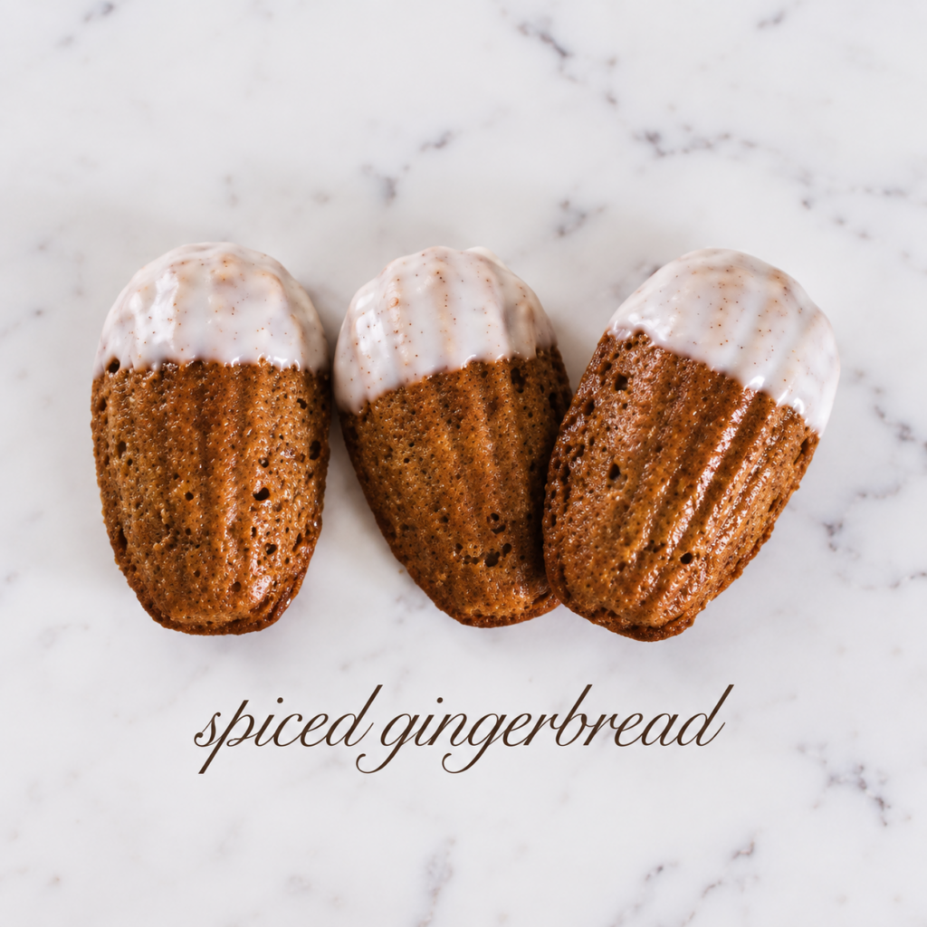 Spiced Gingerbread Madeleines with warm spices and molasses, finished with a smooth vanilla glaze.