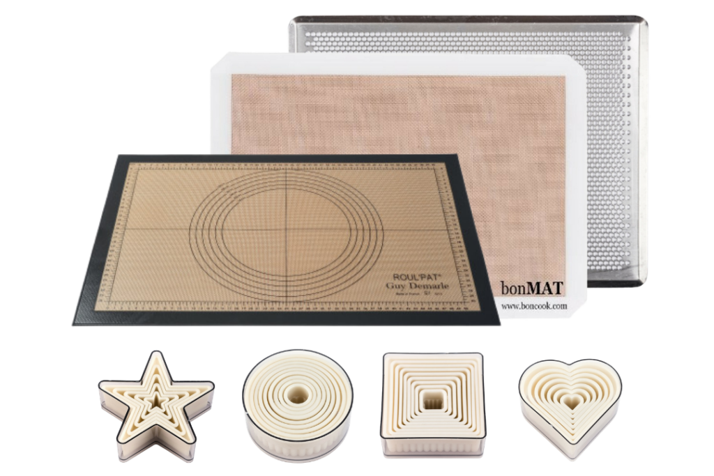 bon COOK Holiday Cookie Decorating with Bonmat, perforated baking sheet, graduated pastry mat, and round, square, heart, and star cutters.