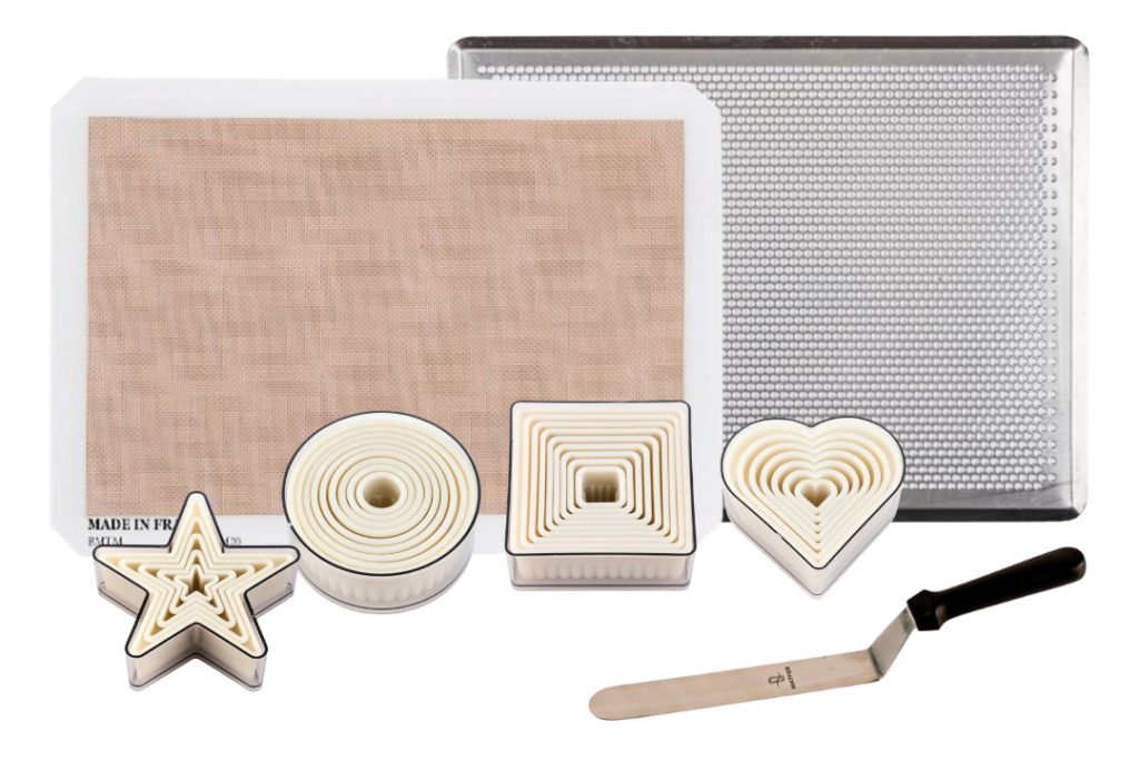 bon COOK Ultimate Cookie Baker with Bonmat, perforated baking sheet, round, square, star, and heart cutters, and offset spatula.